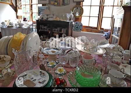 Antique china and glass on display in an antiques centre in Leominster, Herefordshire Stock Photo
