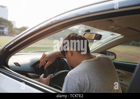 Illness, exhausted, disease, tired for overworked concept. Asian businessman having headache from migraine while he driving car. Stock Photo