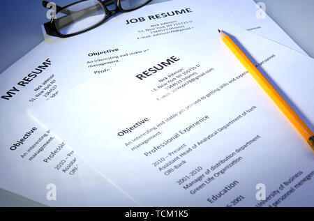 Closeup of resume with pencil on - Closeup Of Resume With Glasses And Pencil On Blue Background Tcm1k5 