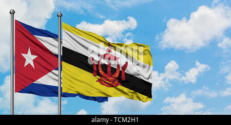 Cuba and Brunei flag waving in the wind against white cloudy blue sky together. Diplomacy concept, international relations. Stock Photo