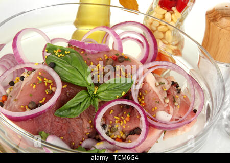 A large piece of pork marinated in bowl close-up isolated on white Stock Photo