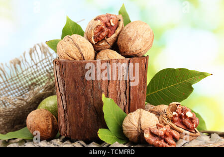 walnuts with green leaves in garden, on green background Stock Photo