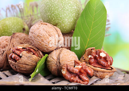 walnuts with green leaves in garden, on green background Stock Photo