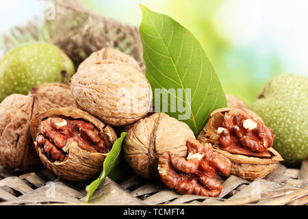 walnuts with green leaves in garden, on green background Stock Photo