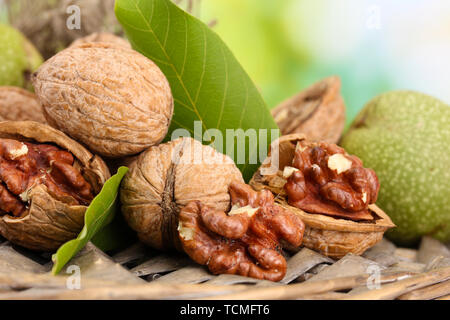 walnuts with green leaves in garden, on green background Stock Photo