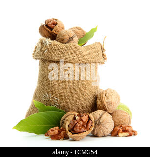 walnuts with green leaves in  burlap bag, isolated on white Stock Photo