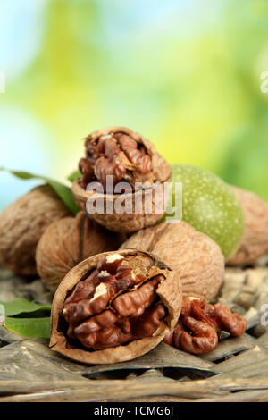 walnuts with green leaves in garden, on green background Stock Photo
