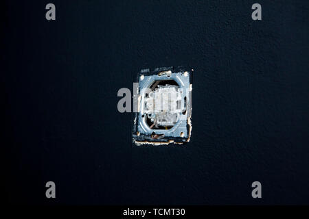 Double white light switches on a black wall background. Horizontal. Stock Photo