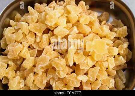 Container with pieces of dehydrated papaya fruits Stock Photo