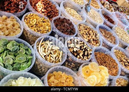Variety of nuts in containers exposed in the market Stock Photo