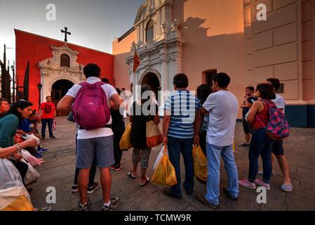 Lima, Peru - April 21, 2018: Group of tourists with tour guide outside church Stock Photo