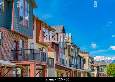 Bright sunlight beaming down on the row of houses with small balconies Stock Photo