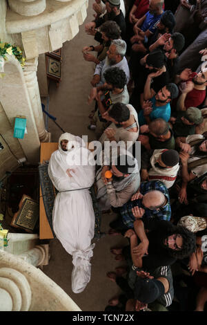 Ad Dana, Syria. 09th June, 2019. People pray during the funeral of Abdel-Baset al-Sarout, 27, a Syrian goalkeeper who joined the armed rebellion against President Bashar al-Assad, after he died on Saturday of injuries sustained in fighting against al-Assad·s forces in the countryside of the province of Hama. The ex-goalkeeper of Syria·s junior team was among the first athletes who joined the anti-al-Assad revolt when it erupted in 2011. Credit: Anas Alkharboutli/dpa/Alamy Live News Stock Photo