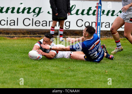 Sale, Greater Manchester, UK. 9th June 2019, Heywood Road stadium, Sale, Greater Manchester, England; Betfred Rugby Championship, Swinton versus Toronto Wolfpack; Chase Stanley of Toronto Wolfpack scores a try under pressure from the Swinton Lions defence to make the score 0 - 14 Credit: Action Plus Sports Images/Alamy Live News Stock Photo