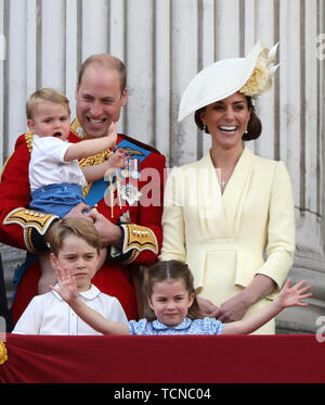 Prince William (Duke of Cambridge) holding Prince Louis, Kate Middleton (Duchess of Cambridge), Prince George, Princess Charlotte, pictured at the Trooping of the Colour 2019. Trooping the Colour marks the Queens official birthday and 1,400 soldiers, 200 horse and 400 musicians parade for Queen Elizabeth II, and the event finishes with an RAF flypast as the Royal Family watch from the balcony at Buckingham Palace. This year the colour will be trooped by 1st Battalion Grenadier Guards Trooping the Colour, London, June 8, 2019 Stock Photo