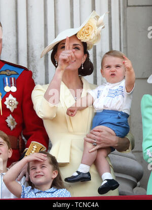 Prince William (Duke of Cambridge), Kate Middleton (Duchess of Cambridge) holding Prince Louis, Princess Charlotte, pictured at the Trooping of the Colour 2019. Trooping the Colour marks the Queens official birthday and 1,400 soldiers, 200 horse and 400 musicians parade for Queen Elizabeth II, and the event finishes with an RAF flypast as the Royal Family watch from the balcony at Buckingham Palace. This year the colour will be trooped by 1st Battalion Grenadier Guards Trooping the Colour, London, June 8, 2019 Stock Photo