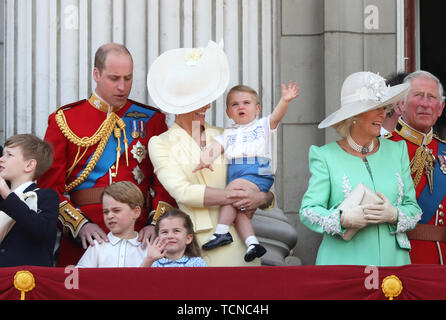 Prince William (Duke of Cambridge), Kate Middleton (Duchess of Cambridge) holding Prince Louis, Prince George, Princess Charlotte, alongside Camilla (Duchess of Cornwall) pictured at the Trooping of the Colour 2019. Trooping the Colour marks the Queens official birthday and 1,400 soldiers, 200 horse and 400 musicians parade for Queen Elizabeth II, and the event finishes with an RAF flypast as the Royal Family watch from the balcony at Buckingham Palace. This year the colour will be trooped by 1st Battalion Grenadier Guards Trooping the Colour, London, June 8, 2019 Stock Photo