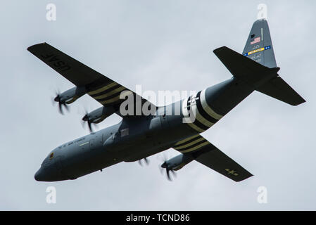 A U.S. Air Force C-130J Super Hercules, assigned to the 62nd Airlift Squadron, Little Rock Air Force Base, Ark., flies over Cherbourg-Maupertus Airport, France, June 6, 2019. The 62nd AS is a legacy squadron, stemming from the 62nd Troop Carrier Squadron, who conducted air drops with Douglas C-47 Dakotas during Operation Neptune June 6, 1944. (U.S. Air Force photo by Senior Airman Devin M. Rumbaugh) Stock Photo