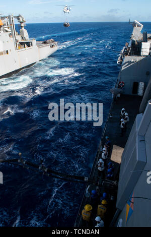 190607-N-DX072-1068 PHILIPPINE SEA (June 7, 2019) The amphibious transport dock ship USS Green Bay (LPD 20) receives cargo and fuel during a replenishment-at-sea with the Military Sealift Command dry cargo and ammunition ship USNS Amelia Earhart (T-AKE 6). Green Bay is underway conducting routine operations as a part of the Wasp Amphibious Ready Group (ARG) in the U.S. 7th Fleet area of operations. (U.S. Navy photo by Mass Communication Specialist 2nd Class Anaid Banuelos Rodriguez) Stock Photo