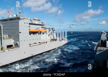 190607-N-DX072-1074 PHILIPPINE SEA (June 7, 2019) The amphibious transport dock ship USS Green Bay (LPD 20) receives cargo during a replenishment-at-sea with the Military Sealift Command dry cargo and ammunition ship USNS Amelia Earhart (T-AKE 6). Green Bay is underway conducting routine operations as a part of the Wasp Amphibious Ready Group (ARG) in the U.S. 7th Fleet area of operations. (U.S. Navy photo by Mass Communication Specialist 2nd Class Anaid Banuelos Rodriguez) Stock Photo