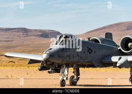 An A-10 Thunderbolt II assigned to the 190th Fighter Squadron, Idaho Air National Guard executes an austere landing and take off on the Freedom Landing Strip, June 6-7, 2019, at the National Training Center, Fort Irwin, California.The capability to land at an austere location enables pilots and ground forces to better integrate their combat capabilities. The 116th Cavalry Brigade Combat Team is training at the National Training Center May 24 through June 20 to prepare for its wartime mission. The rotation builds unit and Soldier proficiency to provide combatant commanders with a trained and re Stock Photo