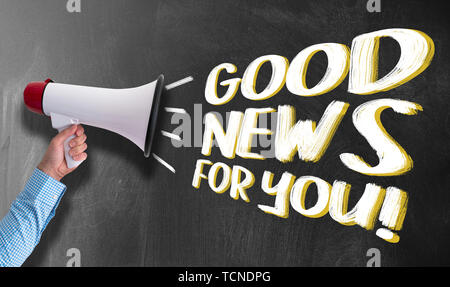 hand of businessman holding megaphone or bullhorn against chalkboard with text GOOD NEWS FOR YOU Stock Photo