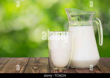 milk in glass and jug on table Stock Photo