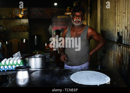 A Tamil cook preparing a Dosa. Stock Photo