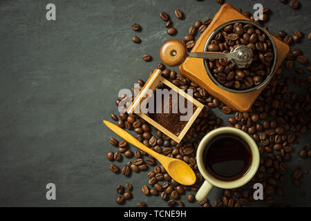 Coffee cup and coffee equipment on black cement floor. Top view and copy space for text. Stock Photo