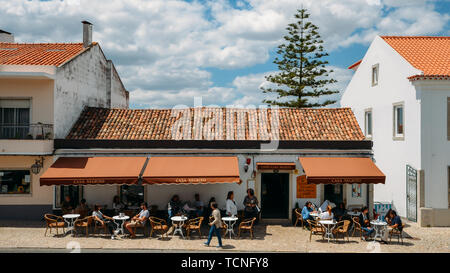 Azeitao, Portugal - June 7, 2019: People relax at a terrace of Casa Negrito cafe in the charming village of Azeitao, Portugal, famous for its wine Stock Photo