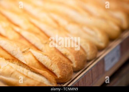 Fresh baked bread in supermarket. Detail of a fresh baked bread in a row  in supermarket. Stock Photo