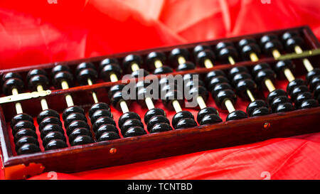 Abacus on red satin. Stock Photo
