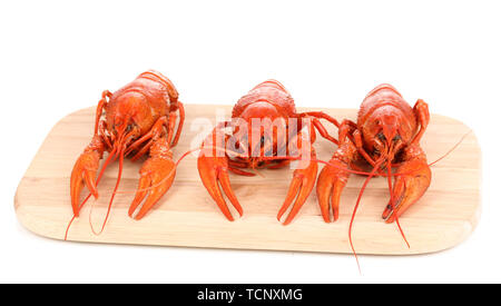 Tasty boiled crayfishes on chopping board isolated on white Stock Photo