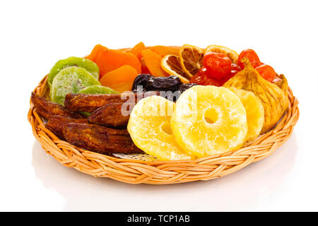 Dried fruits on wicker plate isolated on white Stock Photo