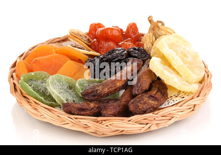 Dried fruits on wicker plate isolated on white Stock Photo