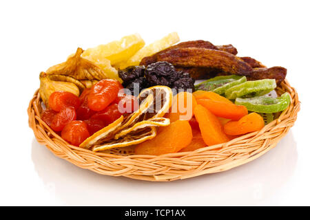 Dried fruits on wicker plate isolated on white Stock Photo