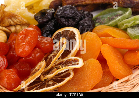 Dried fruits on wicker plate close-up Stock Photo