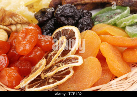 Dried fruits on wicker plate close-up Stock Photo