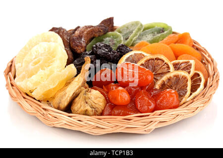 Dried fruits on wicker plate isolated on white Stock Photo