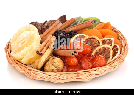 Dried fruits on wicker plate isolated on white Stock Photo