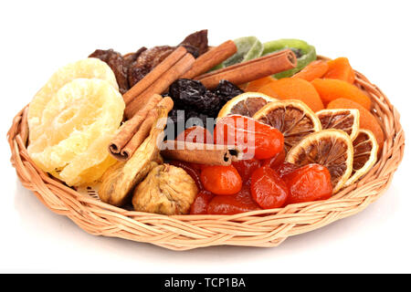 Dried fruits on wicker plate isolated on white Stock Photo