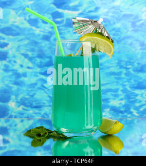 Glass of blue cocktail on blue background Stock Photo