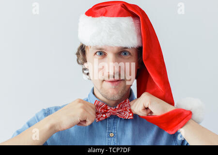 Man with beard wearing bowtie and New Year hat, hipster style Stock Photo