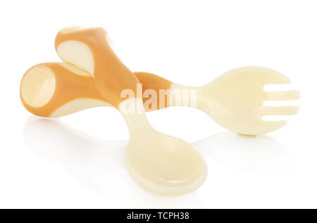 Small beige spoon and fork for babies isolated on white Stock Photo