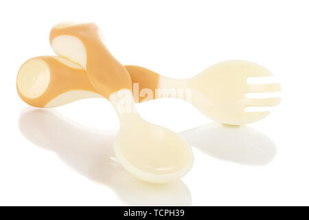 Small beige spoon and fork for babies isolated on white Stock Photo
