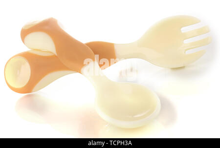 Small beige spoon and fork for babies isolated on white Stock Photo