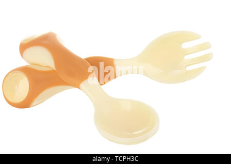 Small beige spoon and fork for babies isolated on white Stock Photo