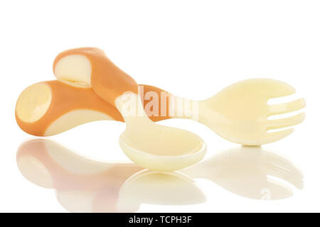 Small beige spoon and fork for babies isolated on white Stock Photo