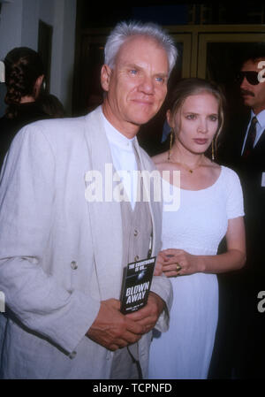 Westwood, California, USA 28th June 1994 Actor Malcolm McDowell and wife Kelley Kuhr attend the premiere of 'Blown Away' on June 28, 1994 at Mann National Theater in Westwood, California, USA. Photo by Barry King/Alamy Stock Photo Stock Photo