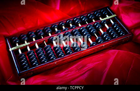Abacus on red satin. Stock Photo